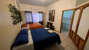 a bedroom with two beds and a balcony at Guamacayan House in Copán Ruinas +22 photos