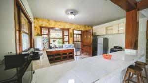 a kitchen with a white counter top in a room at Guamacayan House in Copán Ruinas