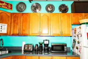 a kitchen with wooden cabinets and a counter top at Hostel Detroit in Detroit