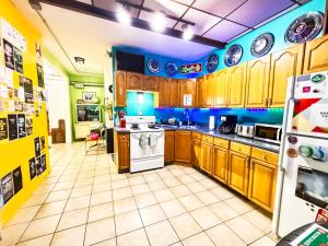 a kitchen with wooden cabinets and a white refrigerator at Hostel Detroit in Detroit