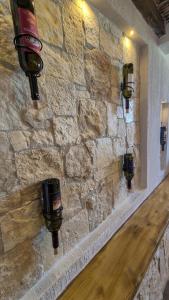 a stone wall with three lights on a wall at Borgo Antico - Barrique Studio in Lotzorai
