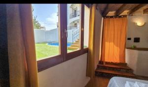 a room with a window with a view of a yard at Borgo Antico - Barrique Studio in Lotzorai +1 photo