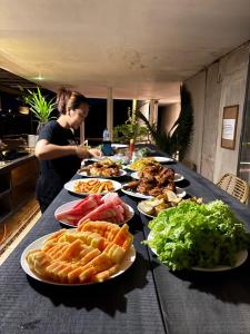 a table with many plates of food on it at The Hide Hostel Canggu in Canggu