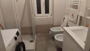 a small bathroom with a toilet and a sink at Le 3 Sirene in Bordighera