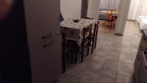 a kitchen with a table and a table and chairs at Le 3 Sirene in Bordighera