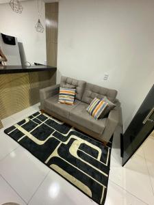 a living room with a couch and a rug at Flat JK em Dona Inês-pb in Dona Inês