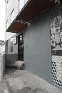 a facade of a building with a door and a window at Adhoc Cintermex in Monterrey