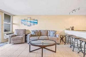 a living room with a couch and a table at Amazing Beachfront Condo by Pool in Hauula