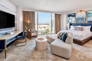 a hotel room with a bed and a tv at Omni Fort Lauderdale Hotel in Fort Lauderdale