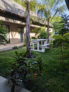 a picnic table in the grass next to a building at Sofitel Inn in Maun