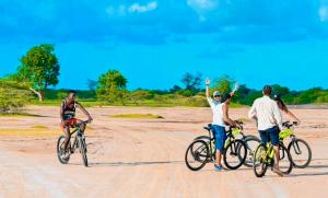 a group of people riding bikes on a dirt road at Gîte du Lac in Niaga