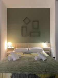a bedroom with a large bed with two towels on it at Casa Di Francesco in Velletri