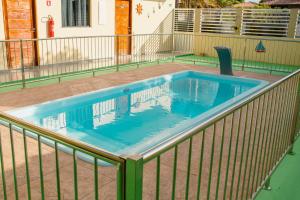 a swimming pool with a metal rail around it at Pousada Iza in Salinópolis