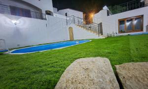 a house with a large yard with a swimming pool at Borgo Antico - Monili di Sardegna in Lotzorai
