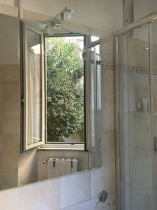 a bathroom with a window and a shower with a mirror at Casa Di Francesco in Velletri +24 photos