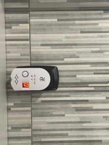 a remote control sitting on top of a tile floor at Casa Di Francesco in Velletri