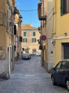 an alley with cars parked on a street between buildings at Casa Di Francesco in Velletri