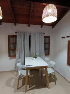 a dining room with a white table and chairs at Potrero Loft in Potrero de Garay +20 photos