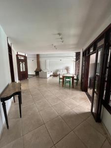 a living room with a table and a couch at Casa Country Niterói in Niterói