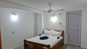 a bedroom with a bed and a ceiling fan at MH Zanzibar in Jambiani