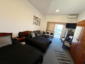 a living room with two beds and a couch at Tabarja Chalet Studio Sea & Mountain View in An Nā‘ūrah