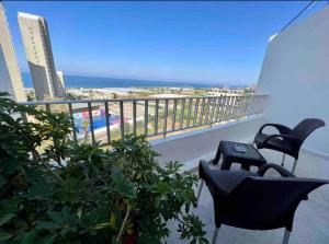 a balcony with chairs and a view of the ocean at Tabarja Chalet Studio Sea & Mountain View in An Nā‘ūrah