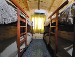 a bedroom with two bunk beds in a cabin at Yacaré INN in Ituzaingó