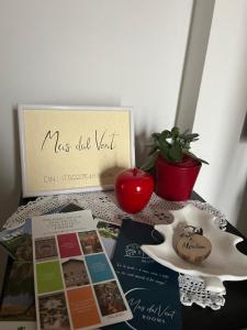 a table with a sign and a potted plant at Mas dal Vent in Valfloriana +44 photos