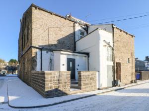 a brick building on the side of a street at The Penthouse at 86 in Rossendale
