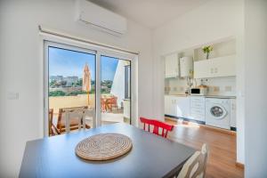 a kitchen and dining room with a table with a view at Ocean View - XL Terrace - Beachfront by Tenório in Lagos
