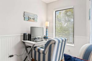 a room with a desk with a computer and a chair at Golf Glenn Villa A205 in Myrtle Beach
