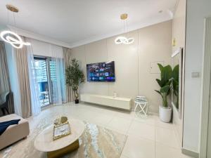 a living room with a tv on the wall at Damac mall street in Dubai +33 photos