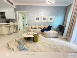 a living room with a couch and a table at Damac mall street in Dubai