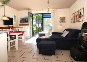 a living room with a couch and a table at "Leuchtturm" in Fuhlendorf