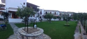 a house with a yard with a swing at Vontzos Hotel in Achladies
