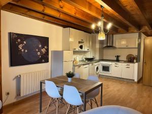 a kitchen with a table and chairs in a room at La plaza de llanes, Plaza Parres Sobrino, 6 in Llanes