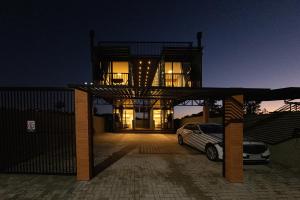 a house with a car parked in front of it at Eco Green Container- Guarda do Embaú SC in Palhoça