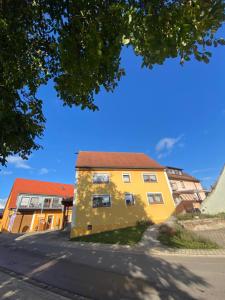 a yellow building on the side of a street at Münsterblick in Wolframs-Eschenbach