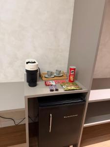 a table with a coffee maker on top of it at Amélia Pousada de Charme in Porto De Galinhas