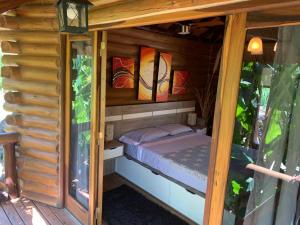 a small bedroom inside of a wooden house at Espacio Natural in Gualeguaychú