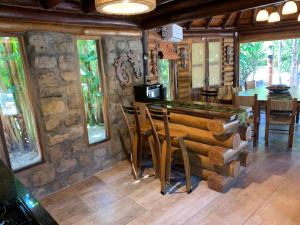 a dining room with a table and some windows at Espacio Natural in Gualeguaychú