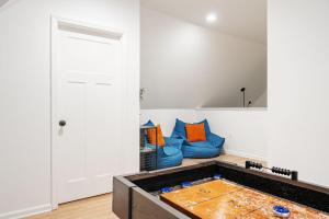 a living room with a blue couch in a room at Indy Getaway - Near Downtown Indy - Sleeps 10! in Indianapolis