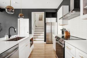 a kitchen with a sink and a refrigerator at Indy Getaway - Near Downtown Indy - Sleeps 10! in Indianapolis