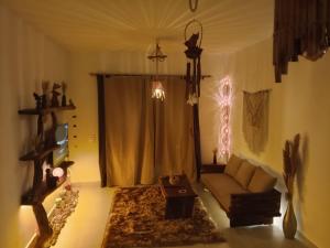 a living room with a couch and a window at Sina Cave in Dahab +40 photos