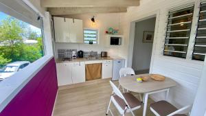 a kitchen and dining room with a table and chairs at Grand Case Beach Steps in Grand Case