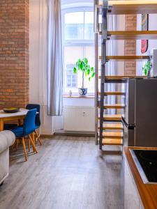 a kitchen with a spiral staircase and a table at The LOFT Ljubljana in Ljubljana +54 photos