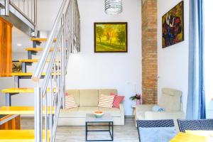 a living room with a staircase and a couch at The LOFT Ljubljana in Ljubljana