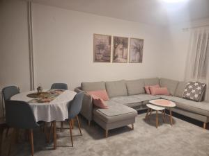 a living room with a couch and a table at Duplex House - Private Home MUNA in Sarajevo