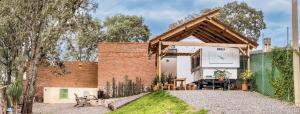 a brick house with a wooden roof at Glamping con Jacuzzi en Guanajuato in Santa Rosa de Lima