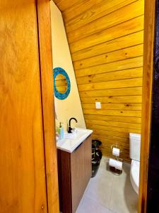 a bathroom with a sink and a toilet at Chale do Boni in Palhoça +13 photos